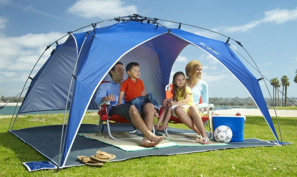 family under a pop up beach tent